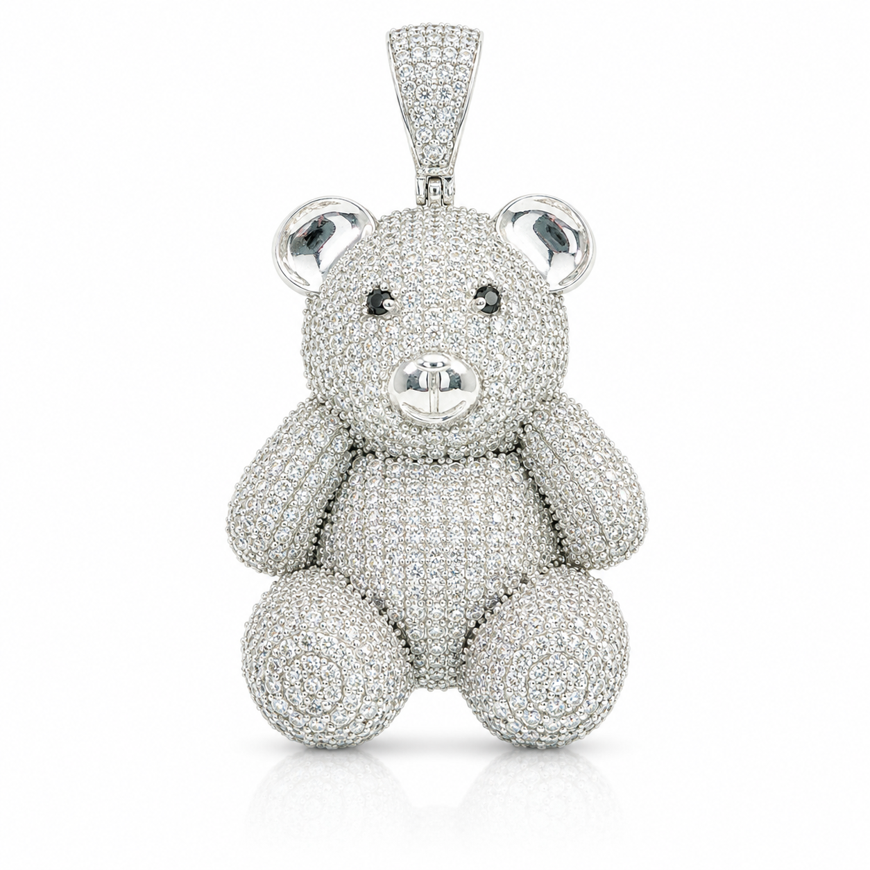 A teddy bear pendant encrusted with sparkling clear gemstones, set in a silver-toned metal and photographed against a clean white background.