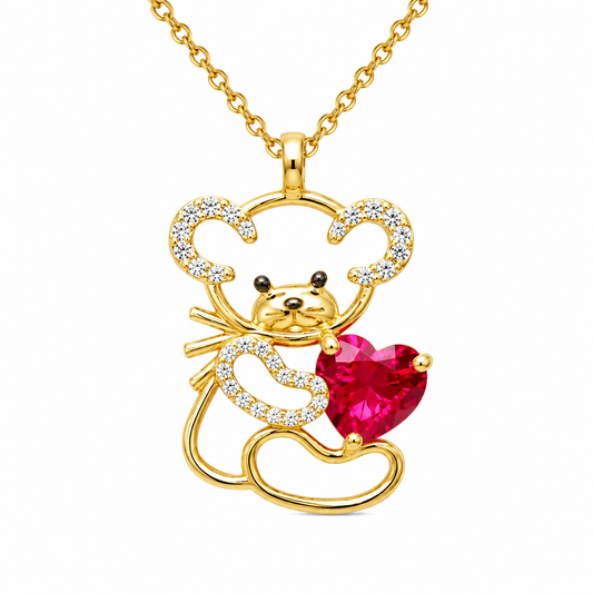 Gold pendant necklace featuring a stylized mouse holding a bright pink heart-shaped gemstone, with small clear stones along the outline, shown on a white background.